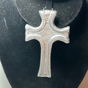 Lightweight metal perhaps aluminum cross that has hanger on it very silver,